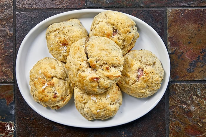 Taking my family's classic buttermilk drop biscuit recipe and give it a sophisticated, savory upgrade with savory ham, melted brie, fig jam, and black pepper. Perfect any time of the day, meal prep, and freeze meals. #ButtermilkBiscuits #BrunchRecipes #SavoryBaking #ComfortFood #stuffedbiscuits #hamandcheesebiscuits