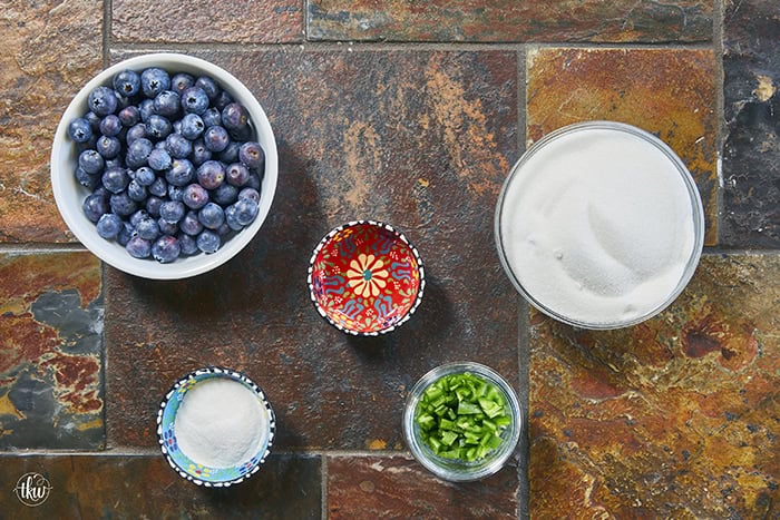 This easy Blueberry Jalapeño Jam recipe uses white balsamic and fresh berries for a flavor bomb that's perfect on burgers, pork, and smoked cream cheese. Whether you're a canning pro or just want a quick refrigerator jam, this simple recipe is a game changer for your next BBQ or charcuterie board! #BlueberryJalapenoJam #SweetHeat #CanningRecipes #HomemadeJam #SummerPreserves #AppetizerRecipes #SmokedCreamCheese #JalapenoBlueberry