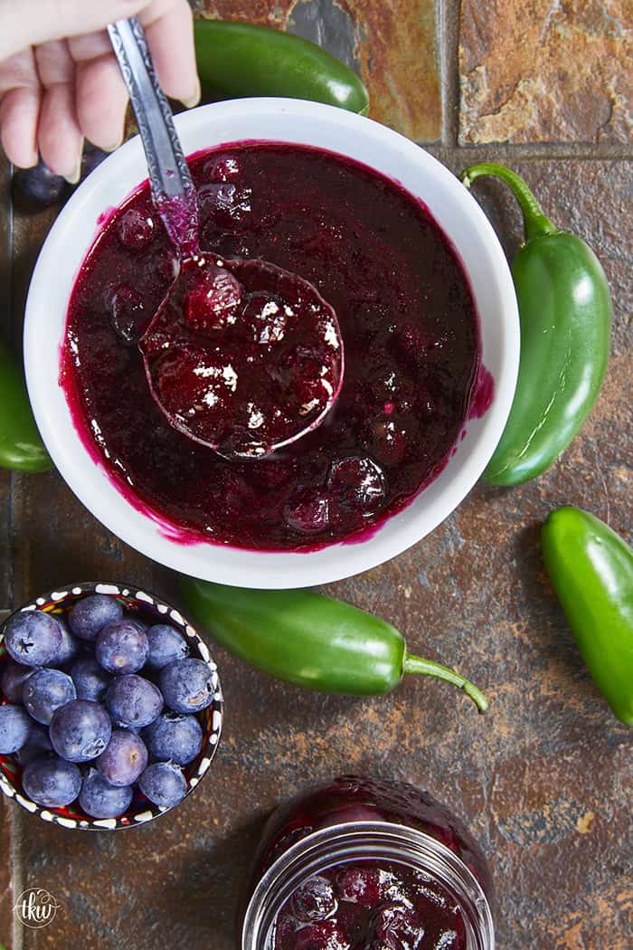 This easy Blueberry Jalapeño Jam recipe uses white balsamic and fresh berries for a flavor bomb that's perfect on burgers, pork, and smoked cream cheese. Whether you're a canning pro or just want a quick refrigerator jam, this simple recipe is a game changer for your next BBQ or charcuterie board! #BlueberryJalapenoJam #SweetHeat #CanningRecipes #HomemadeJam #SummerPreserves #AppetizerRecipes #SmokedCreamCheese #JalapenoBlueberry