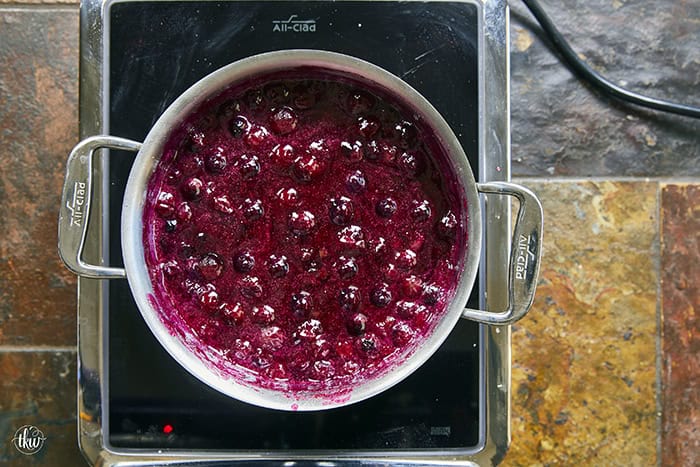 This easy Blueberry Jalapeño Jam recipe uses white balsamic and fresh berries for a flavor bomb that's perfect on burgers, pork, and smoked cream cheese. Whether you're a canning pro or just want a quick refrigerator jam, this simple recipe is a game changer for your next BBQ or charcuterie board! #BlueberryJalapenoJam #SweetHeat #CanningRecipes #HomemadeJam #SummerPreserves #AppetizerRecipes #SmokedCreamCheese #JalapenoBlueberry