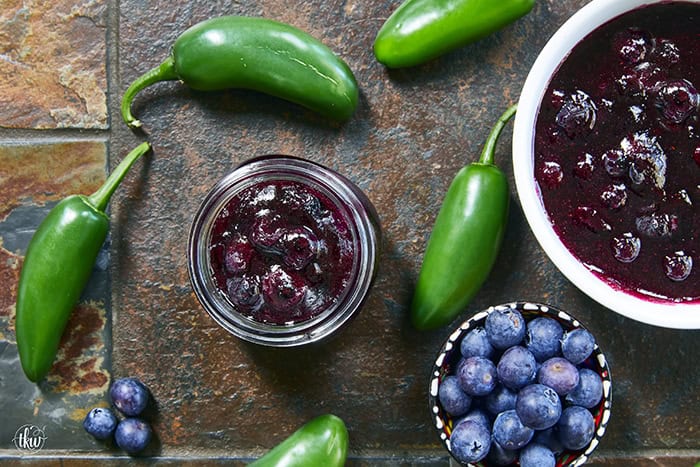 This easy Blueberry Jalapeño Jam recipe uses white balsamic and fresh berries for a flavor bomb that's perfect on burgers, pork, and smoked cream cheese. Whether you're a canning pro or just want a quick refrigerator jam, this simple recipe is a game changer for your next BBQ or charcuterie board! #BlueberryJalapenoJam #SweetHeat #CanningRecipes #HomemadeJam #SummerPreserves #AppetizerRecipes #SmokedCreamCheese #JalapenoBlueberry