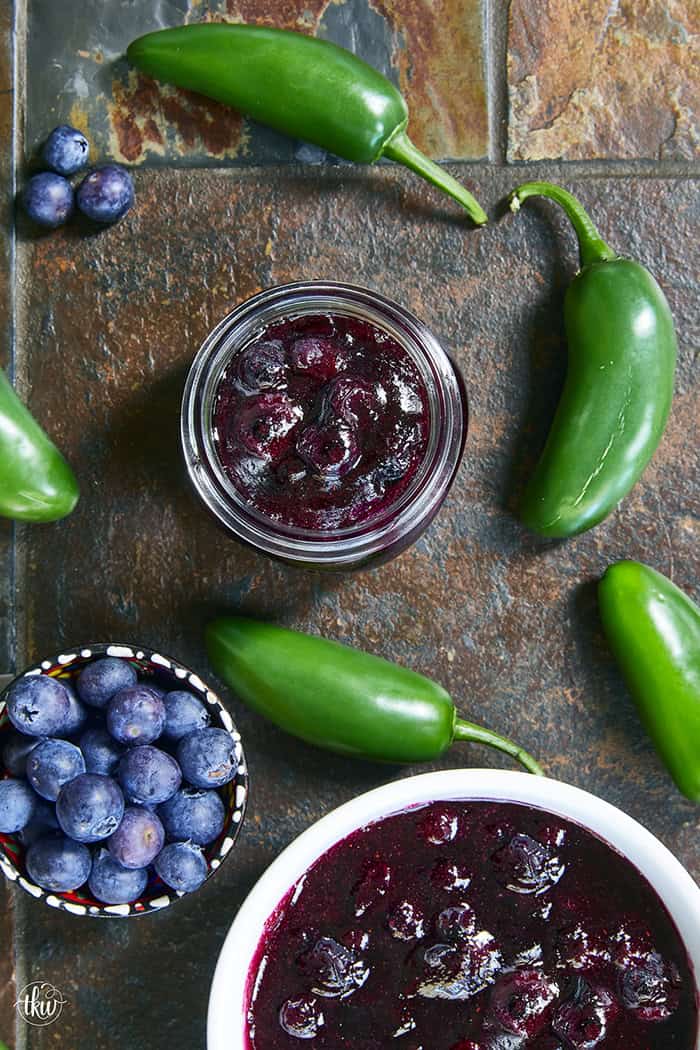 This easy Blueberry Jalapeño Jam recipe uses white balsamic and fresh berries for a flavor bomb that's perfect on burgers, pork, and smoked cream cheese. Whether you're a canning pro or just want a quick refrigerator jam, this simple recipe is a game changer for your next BBQ or charcuterie board! #BlueberryJalapenoJam #SweetHeat #CanningRecipes #HomemadeJam #SummerPreserves #AppetizerRecipes #SmokedCreamCheese #JalapenoBlueberry