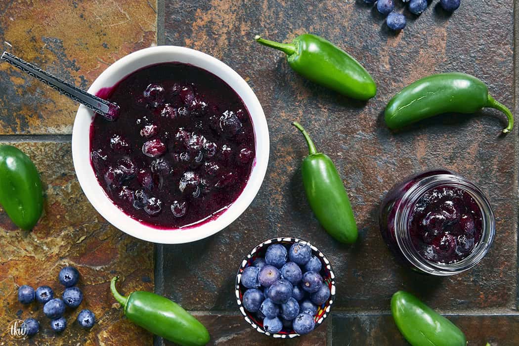 This easy Blueberry Jalapeño Jam recipe uses white balsamic and fresh berries for a flavor bomb that's perfect on burgers, pork, and smoked cream cheese. Whether you're a canning pro or just want a quick refrigerator jam, this simple recipe is a game changer for your next BBQ or charcuterie board! #BlueberryJalapenoJam #SweetHeat #CanningRecipes #HomemadeJam #SummerPreserves #AppetizerRecipes #SmokedCreamCheese #JalapenoBlueberry