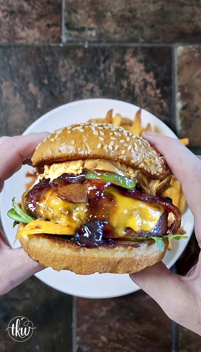 This Blueberry Jalapeño PB&J Bacon Cheeseburger is the best burger of the summer! Smoked ground brisket, melted cheddar, crispy bacon, and a sweet heat kick of blueberry jalapeño balsamic jam. #PBJBurger #BurgerRecipes #GrillingSeason