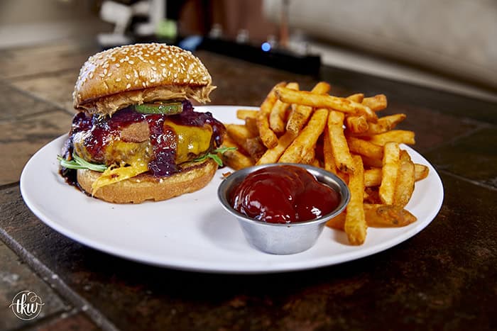 This Blueberry Jalapeño PB&J Bacon Cheeseburger is the best burger of the summer! Smoked ground brisket, melted cheddar, crispy bacon, and a sweet heat kick of blueberry jalapeño balsamic jam. #PBJBurger #BurgerRecipes #GrillingSeason