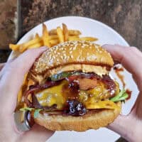 This Blueberry Jalapeño PB&J Bacon Cheeseburger is the best burger of the summer! Smoked ground brisket, melted cheddar, crispy bacon, and a sweet heat kick of blueberry jalapeño balsamic jam. #PBJBurger #BurgerRecipes #GrillingSeason