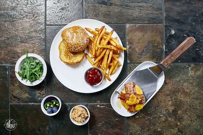 This Blueberry Jalapeño PB&J Bacon Cheeseburger is the best burger of the summer! Smoked ground brisket, melted cheddar, crispy bacon, and a sweet heat kick of blueberry jalapeño balsamic jam. #PBJBurger #BurgerRecipes #GrillingSeason