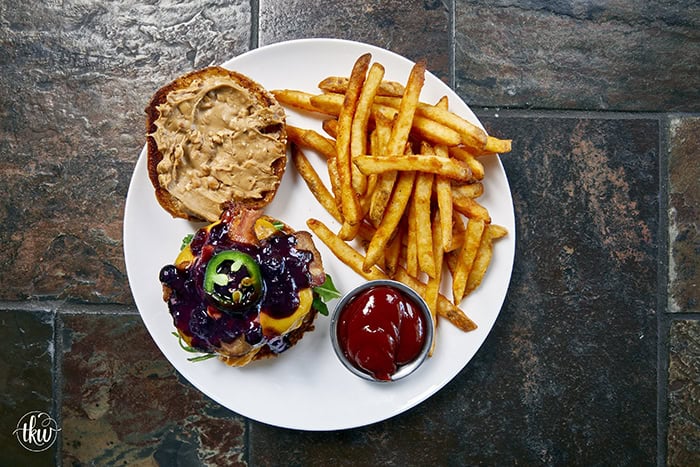This Blueberry Jalapeño PB&J Bacon Cheeseburger is the best burger of the summer! Smoked ground brisket, melted cheddar, crispy bacon, and a sweet heat kick of blueberry jalapeño balsamic jam. #PBJBurger #BurgerRecipes #GrillingSeason