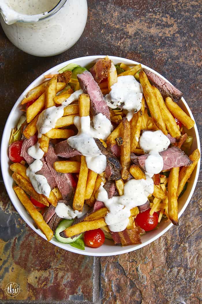 This authentic Pittsburgh Steak Salad features juicy, seared steak strips and a mountain of crispy, golden fries over fresh romaine , veggies, and cool ranch. It’s a Steel City classic that proves fries belong on everything! Perfect for a hearty lunch or a quick weeknight dinner. #PittsburghSteakSalad #SteelCityEats #FriesOnEverything #SaladGoals #EasyDinner