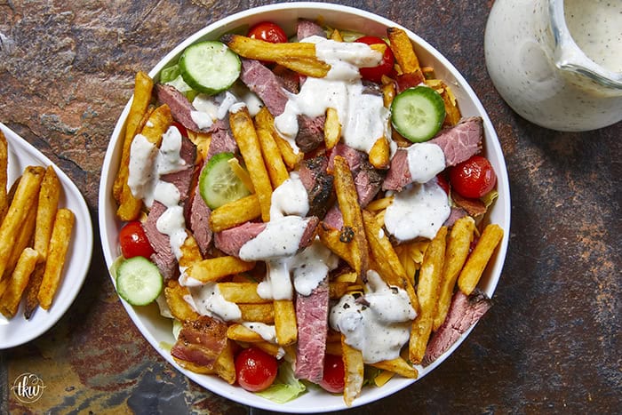 This authentic Pittsburgh Steak Salad features juicy, seared steak strips and a mountain of crispy, golden fries over fresh romaine , veggies, and cool ranch. It’s a Steel City classic that proves fries belong on everything! Perfect for a hearty lunch or a quick weeknight dinner. #PittsburghSteakSalad #SteelCityEats #FriesOnEverything #SaladGoals #EasyDinner