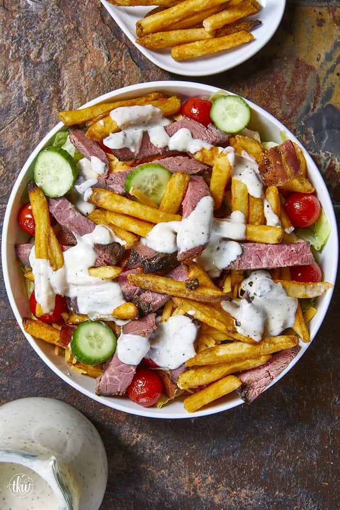 This authentic Pittsburgh Steak Salad features juicy, seared steak strips and a mountain of crispy, golden fries over fresh romaine , veggies, and cool ranch. It’s a Steel City classic that proves fries belong on everything! Perfect for a hearty lunch or a quick weeknight dinner. #PittsburghSteakSalad #SteelCityEats #FriesOnEverything #SaladGoals #EasyDinner