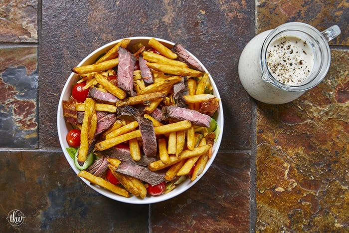 This authentic Pittsburgh Steak Salad features juicy, seared steak strips and a mountain of crispy, golden fries over fresh romaine , veggies, and cool ranch. It’s a Steel City classic that proves fries belong on everything! Perfect for a hearty lunch or a quick weeknight dinner. #PittsburghSteakSalad #SteelCityEats #FriesOnEverything #SaladGoals #EasyDinner