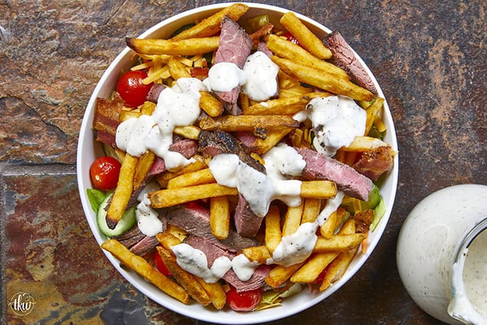 This authentic Pittsburgh Steak Salad features juicy, seared steak strips and a mountain of crispy, golden fries over fresh romaine , veggies, and cool ranch. It’s a Steel City classic that proves fries belong on everything! Perfect for a hearty lunch or a quick weeknight dinner. #PittsburghSteakSalad #SteelCityEats #FriesOnEverything #SaladGoals #EasyDinner