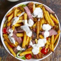 This authentic Pittsburgh Steak Salad features juicy, seared steak strips and a mountain of crispy, golden fries over fresh romaine , veggies, and cool ranch. It’s a Steel City classic that proves fries belong on everything! Perfect for a hearty lunch or a quick weeknight dinner. #PittsburghSteakSalad #SteelCityEats #FriesOnEverything #SaladGoals #EasyDinner