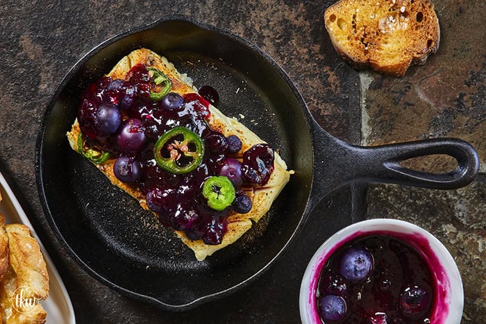 Looking for a killer appetizer? Try this Smoked Cream Cheese with Blueberry and Jalapeno Jam! A block of cream cheese gets a rich, wood-fired smoky flavor, then gets topped with a sweet-heat berry jam. It takes under 10 minutes of hands-on prep, and I'll show you how to make it in a smoker, grill, or kitchen oven. It is the perfect dip for party crackers, a spread for bagels, or a burger topper! #SmokedCreamCheese #SmokerRecipes #EasyAppetizers