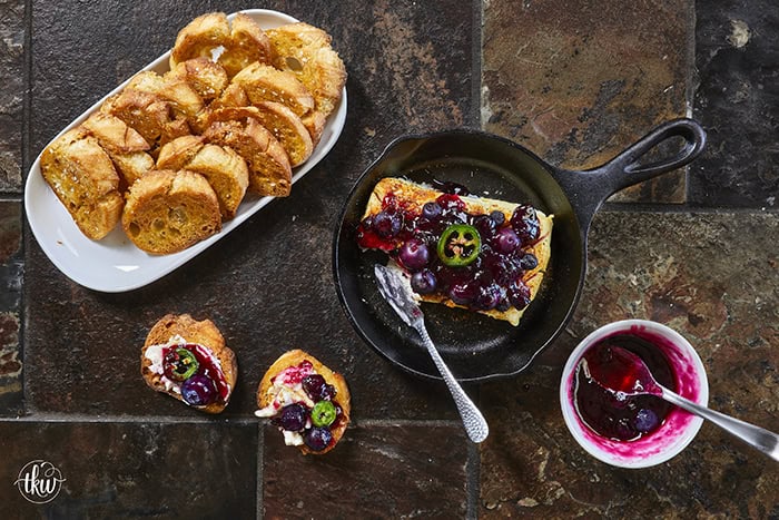 Looking for a killer appetizer? Try this Smoked Cream Cheese with Blueberry and Jalapeno Jam! A block of cream cheese gets a rich, wood-fired smoky flavor, then gets topped with a sweet-heat berry jam. It takes under 10 minutes of hands-on prep, and I'll show you how to make it in a smoker, grill, or kitchen oven. It is the perfect dip for party crackers, a spread for bagels, or a burger topper! #SmokedCreamCheese #SmokerRecipes #EasyAppetizers
