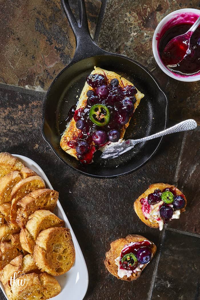Looking for a killer appetizer? Try this Smoked Cream Cheese with Blueberry and Jalapeno Jam! A block of cream cheese gets a rich, wood-fired smoky flavor, then gets topped with a sweet-heat berry jam. It takes under 10 minutes of hands-on prep, and I'll show you how to make it in a smoker, grill, or kitchen oven. It is the perfect dip for party crackers, a spread for bagels, or a burger topper! #SmokedCreamCheese #SmokerRecipes #EasyAppetizers