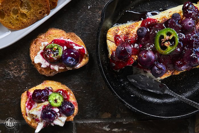 Looking for a killer appetizer? Try this Smoked Cream Cheese with Blueberry and Jalapeno Jam! A block of cream cheese gets a rich, wood-fired smoky flavor, then gets topped with a sweet-heat berry jam. It takes under 10 minutes of hands-on prep, and I'll show you how to make it in a smoker, grill, or kitchen oven. It is the perfect dip for party crackers, a spread for bagels, or a burger topper! #SmokedCreamCheese #SmokerRecipes #EasyAppetizers