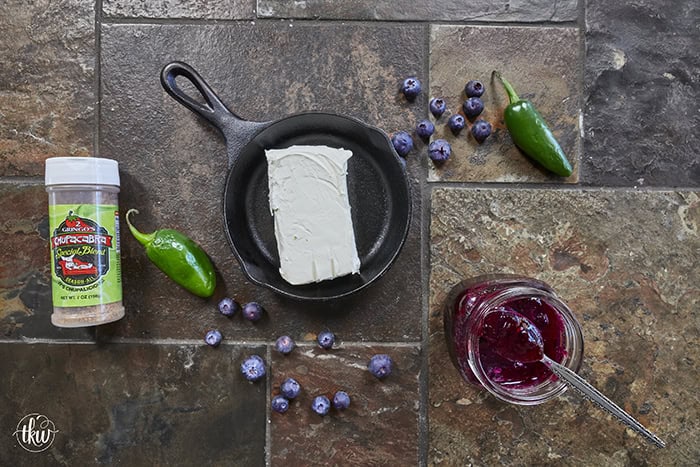 Looking for a killer appetizer? Try this Smoked Cream Cheese with Blueberry and Jalapeno Jam! A block of cream cheese gets a rich, wood-fired smoky flavor, then gets topped with a sweet-heat berry jam. It takes under 10 minutes of hands-on prep, and I'll show you how to make it in a smoker, grill, or kitchen oven. It is the perfect dip for party crackers, a spread for bagels, or a burger topper! #SmokedCreamCheese #SmokerRecipes #EasyAppetizers
