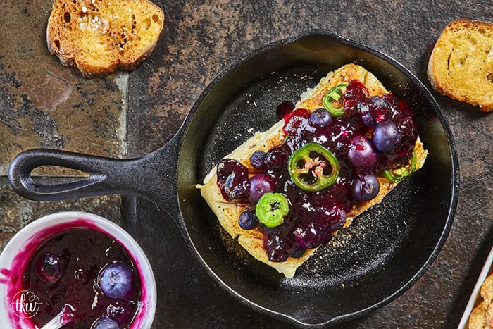 Looking for a killer appetizer? Try this Smoked Cream Cheese with Blueberry and Jalapeno Jam! A block of cream cheese gets a rich, wood-fired smoky flavor, then gets topped with a sweet-heat berry jam. It takes under 10 minutes of hands-on prep, and I'll show you how to make it in a smoker, grill, or kitchen oven. It is the perfect dip for party crackers, a spread for bagels, or a burger topper! #SmokedCreamCheese #SmokerRecipes #EasyAppetizers