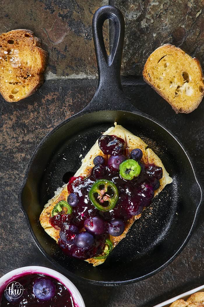 Looking for a killer appetizer? Try this Smoked Cream Cheese with Blueberry and Jalapeno Jam! A block of cream cheese gets a rich, wood-fired smoky flavor, then gets topped with a sweet-heat berry jam. It takes under 10 minutes of hands-on prep, and I'll show you how to make it in a smoker, grill, or kitchen oven. It is the perfect dip for party crackers, a spread for bagels, or a burger topper! #SmokedCreamCheese #SmokerRecipes #EasyAppetizers