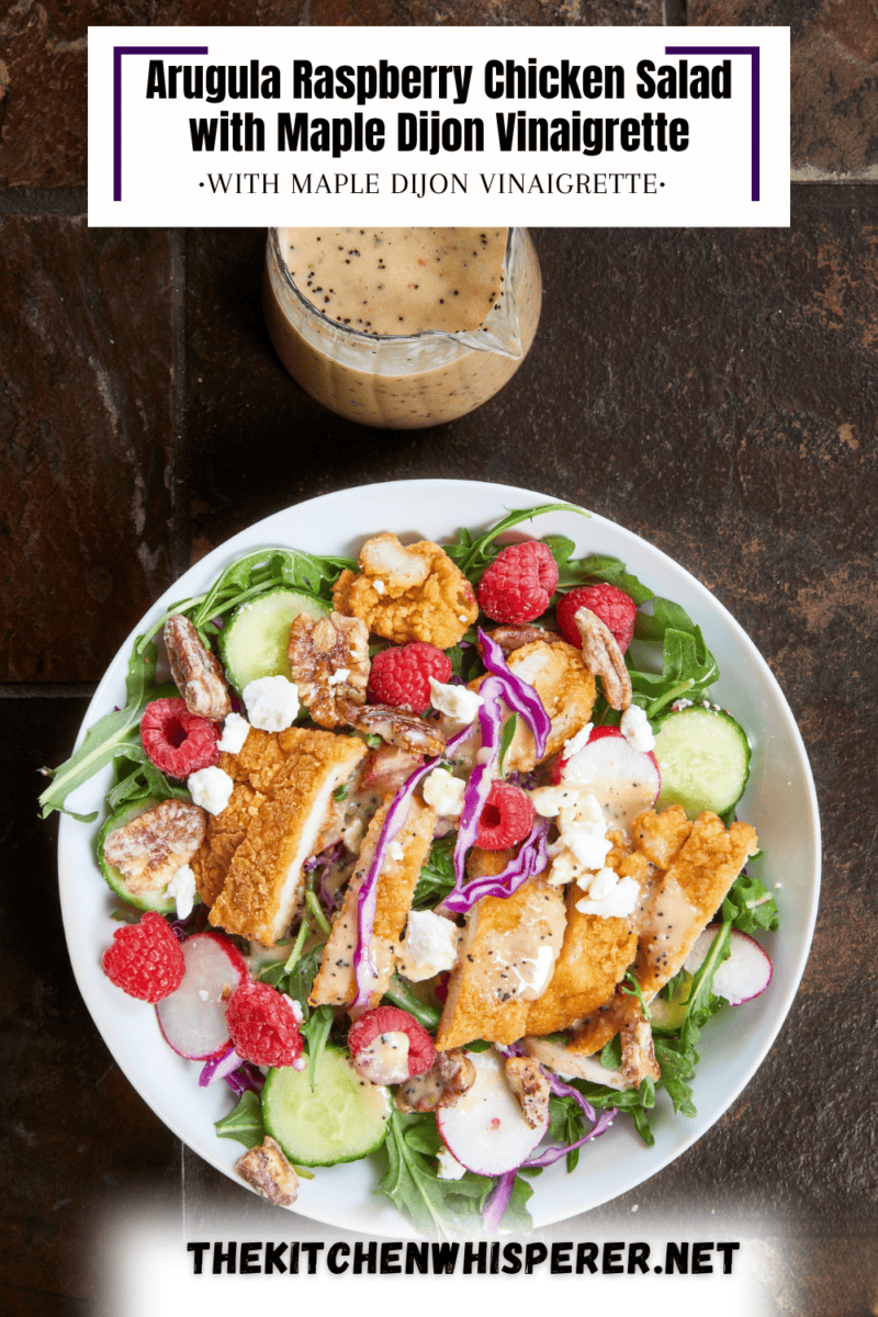 This Arugula Raspberry Chicken Salad is the perfect mix of sweet and savory. Tender chicken, juicy raspberries, sharp radishes, feta, & candied pecans topped with a homemade maple Dijon vinaigrette. #ChickenSaladRecipes #ArugulaSalad #SummerSalad
