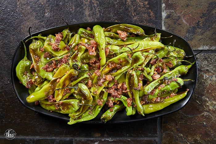 Blistered to perfection and tossed in a sticky, homemade garlic-honey glaze, these shishito peppers hit every single craving. Top them with crispy bacon crumbles for a 15-minute, sweet-and-smoky umami bomb. #ShishitoPeppers #honeygarlicsauce #fingerfoods