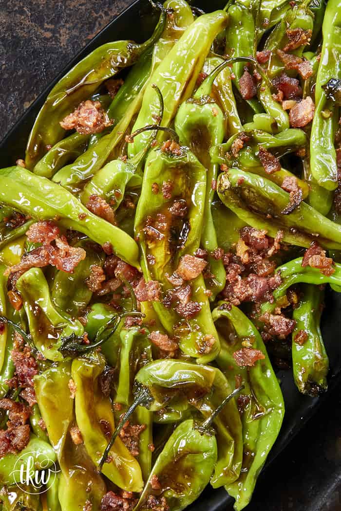 Blistered to perfection and tossed in a sticky, homemade garlic-honey glaze, these shishito peppers hit every single craving. Top them with crispy bacon crumbles for a 15-minute, sweet-and-smoky umami bomb. #ShishitoPeppers #honeygarlicsauce #fingerfoods