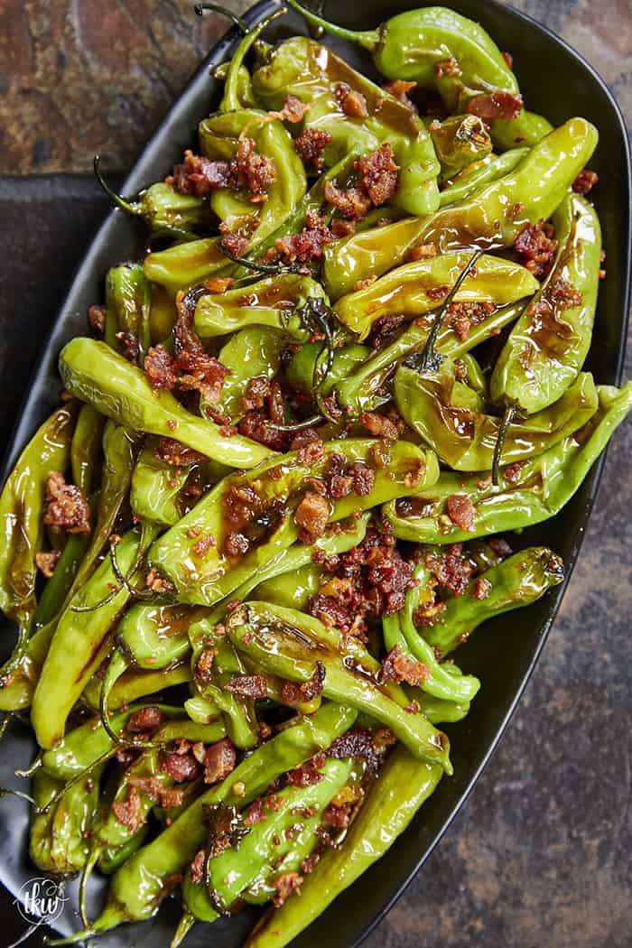 Blistered to perfection and tossed in a sticky, homemade garlic-honey glaze, these shishito peppers hit every single craving. Top them with crispy bacon crumbles for a 15-minute, sweet-and-smoky umami bomb. #ShishitoPeppers #honeygarlicsauce #fingerfoods