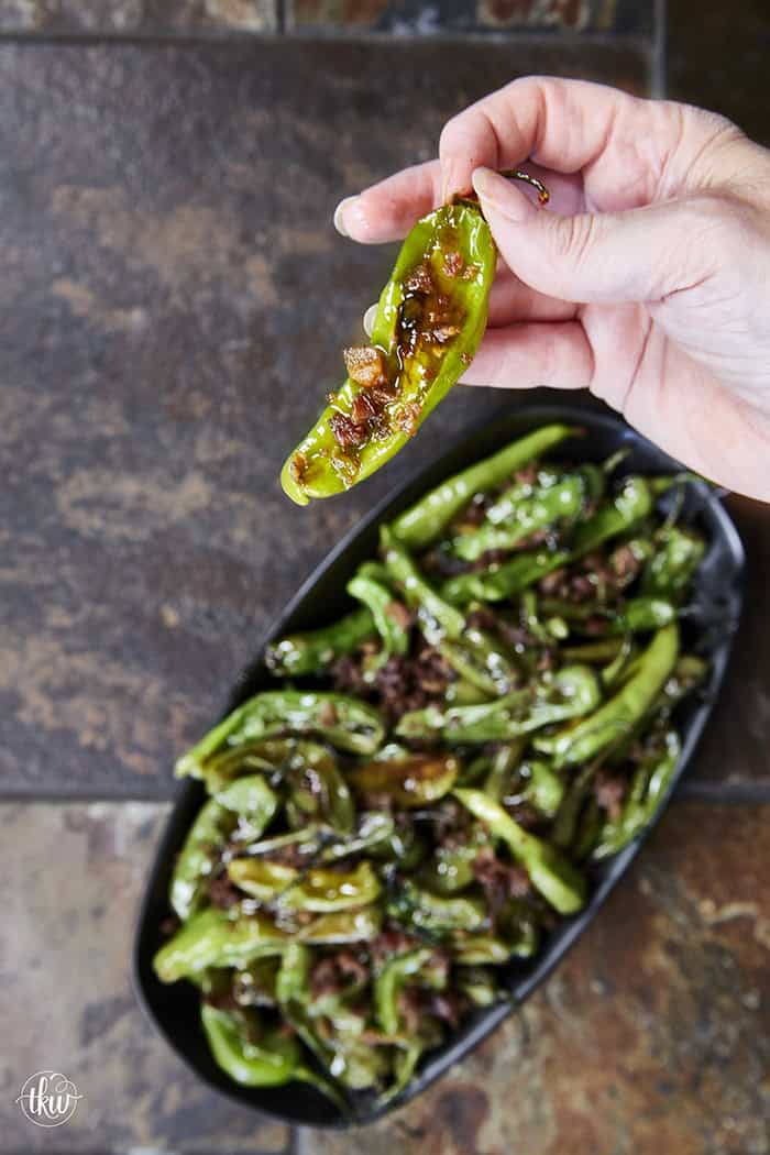 Blistered to perfection and tossed in a sticky, homemade garlic-honey glaze, these shishito peppers hit every single craving. Top them with crispy bacon crumbles for a 15-minute, sweet-and-smoky umami bomb. #ShishitoPeppers #honeygarlicsauce #fingerfoods