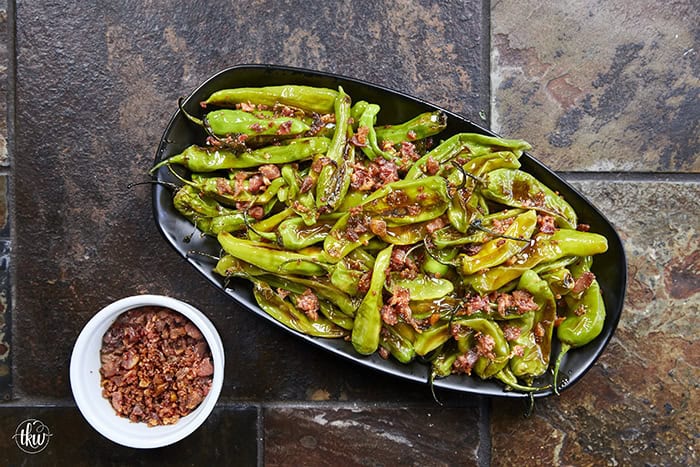 Blistered to perfection and tossed in a sticky, homemade garlic-honey glaze, these shishito peppers hit every single craving. Top them with crispy bacon crumbles for a 15-minute, sweet-and-smoky umami bomb. #ShishitoPeppers #honeygarlicsauce #fingerfoods