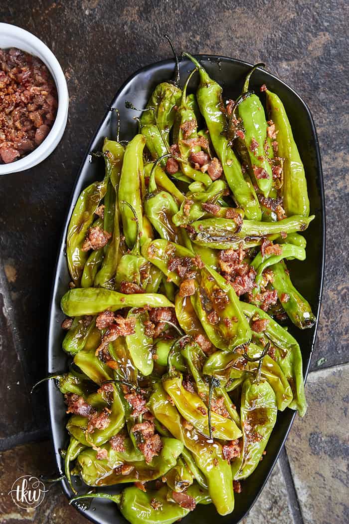 Blistered to perfection and tossed in a sticky, homemade garlic-honey glaze, these shishito peppers hit every single craving. Top them with crispy bacon crumbles for a 15-minute, sweet-and-smoky umami bomb. #ShishitoPeppers #honeygarlicsauce #fingerfoods