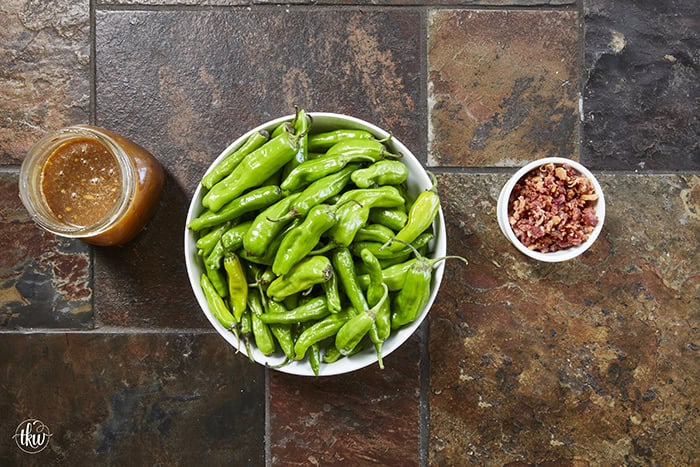 Blistered to perfection and tossed in a sticky, homemade garlic-honey glaze, these shishito peppers hit every single craving. Top them with crispy bacon crumbles for a 15-minute, sweet-and-smoky umami bomb. #ShishitoPeppers #honeygarlicsauce #fingerfoods