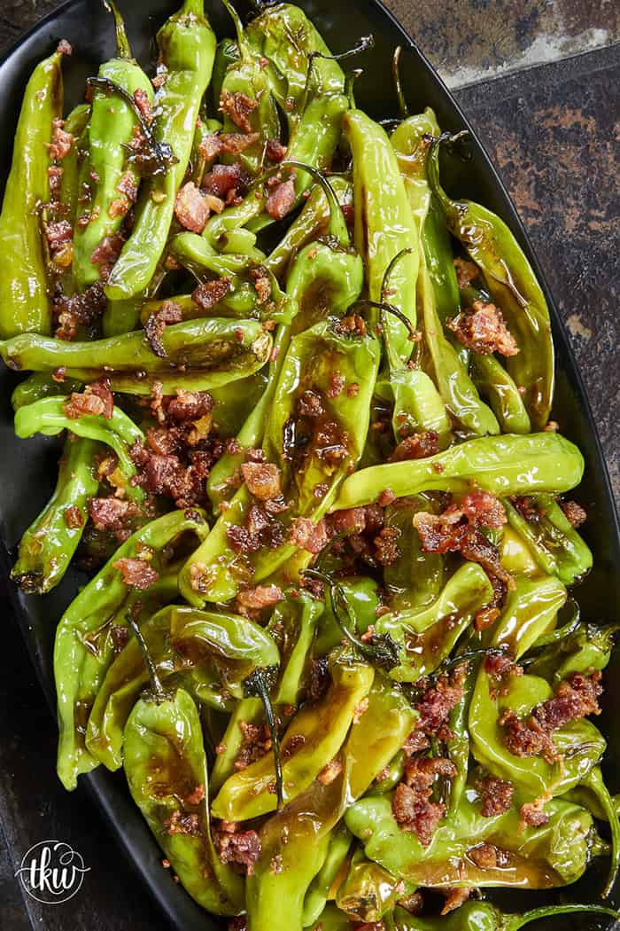 Blistered to perfection and tossed in a sticky, homemade garlic-honey glaze, these shishito peppers hit every single craving. Top them with crispy bacon crumbles for a 15-minute, sweet-and-smoky umami bomb. #ShishitoPeppers #honeygarlicsauce #fingerfoods