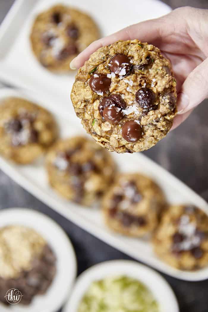 Turn fresh garden zucchini into the ultimate decadent dessert! These thick, chewy oatmeal zucchini chocolate chip cookies pack the perfect balance of hearty oats and gooey dark chocolate pockets, all with deep notes of brown sugar and molasses. Discover the dual-oat secret to keeping these bakery-style cookies perfectly chewy and never cakey. #zucchinicookies #oatmealchocolatechip #cookiesofpinterest