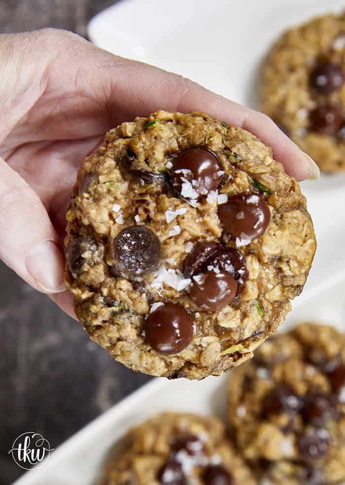 Turn fresh garden zucchini into the ultimate decadent dessert! These thick, chewy oatmeal zucchini chocolate chip cookies pack the perfect balance of hearty oats and gooey dark chocolate pockets, all with deep notes of brown sugar and molasses. Discover the dual-oat secret to keeping these bakery-style cookies perfectly chewy and never cakey. #zucchinicookies #oatmealchocolatechip #cookiesofpinterest