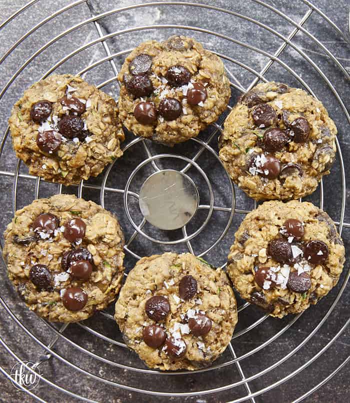 Turn fresh garden zucchini into the ultimate decadent dessert! These thick, chewy oatmeal zucchini chocolate chip cookies pack the perfect balance of hearty oats and gooey dark chocolate pockets, all with deep notes of brown sugar and molasses. Discover the dual-oat secret to keeping these bakery-style cookies perfectly chewy and never cakey. #zucchinicookies #oatmealchocolatechip #cookiesofpinterest