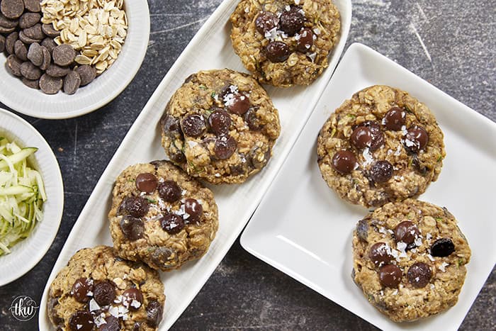 Turn fresh garden zucchini into the ultimate decadent dessert! These thick, chewy oatmeal zucchini chocolate chip cookies pack the perfect balance of hearty oats and gooey dark chocolate pockets, all with deep notes of brown sugar and molasses. Discover the dual-oat secret to keeping these bakery-style cookies perfectly chewy and never cakey. #zucchinicookies #oatmealchocolatechip #cookiesofpinterest