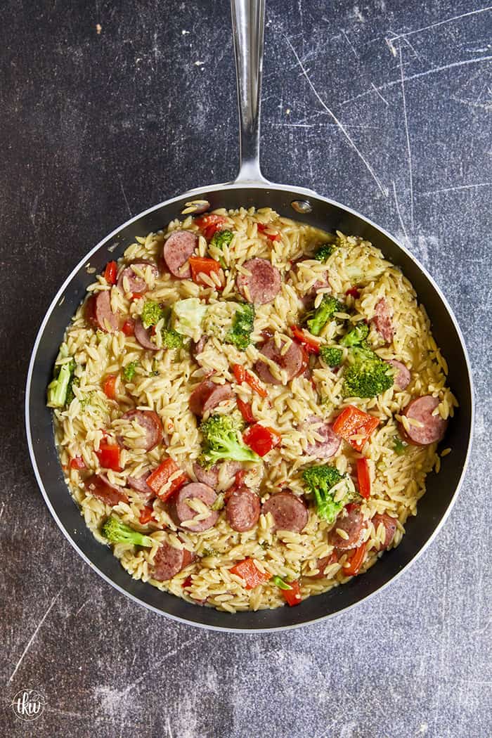 20-minute weeknight dinner made in just ONE skillet! This Sausage Broccoli Orzo combines smoky kielbasa, tender broccoli, and a velvety Parmesan herb sauce—no heavy cream needed. Perfect for busy nights and meal prep! #thekitchenwhisperer #20minutemeals #onepanmeals