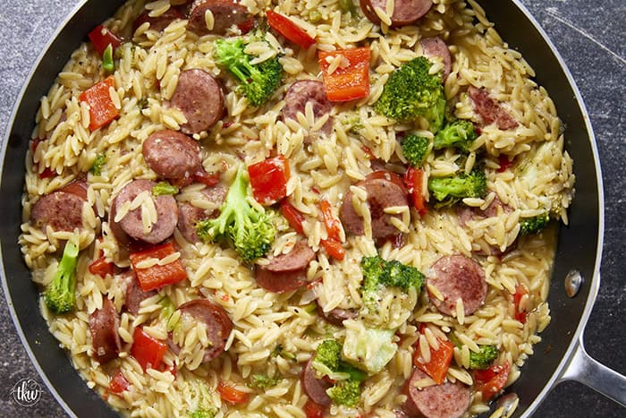 20-minute weeknight dinner made in just ONE skillet! This Sausage Broccoli Orzo combines smoky kielbasa, tender broccoli, and a velvety Parmesan herb sauce—no heavy cream needed. Perfect for busy nights and meal prep! #thekitchenwhisperer #20minutemeals #onepanmeals