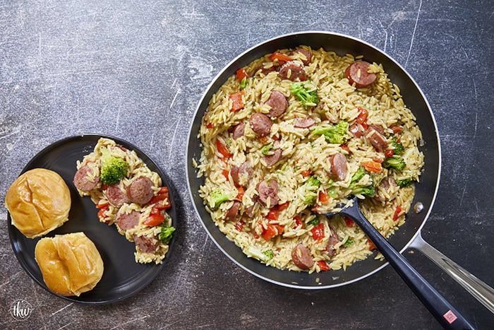 20-minute weeknight dinner made in just ONE skillet! This Sausage Broccoli Orzo combines smoky kielbasa, tender broccoli, and a velvety Parmesan herb sauce—no heavy cream needed. Perfect for busy nights and meal prep! #thekitchenwhisperer #20minutemeals #onepanmeals