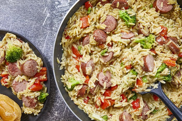 20-minute weeknight dinner made in just ONE skillet! This Sausage Broccoli Orzo combines smoky kielbasa, tender broccoli, and a velvety Parmesan herb sauce—no heavy cream needed. Perfect for busy nights and meal prep! #thekitchenwhisperer #20minutemeals #onepanmeals