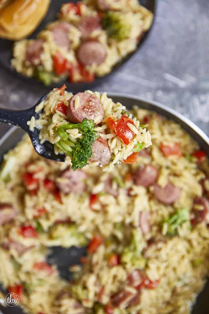 20-minute weeknight dinner made in just ONE skillet! This Sausage Broccoli Orzo combines smoky kielbasa, tender broccoli, and a velvety Parmesan herb sauce—no heavy cream needed. Perfect for busy nights and meal prep! #thekitchenwhisperer #20minutemeals #onepanmeals