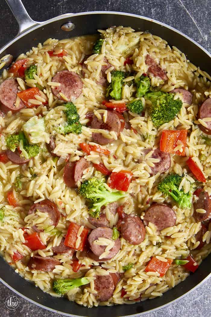 20-minute weeknight dinner made in just ONE skillet! This Sausage Broccoli Orzo combines smoky kielbasa, tender broccoli, and a velvety Parmesan herb sauce—no heavy cream needed. Perfect for busy nights and meal prep! #thekitchenwhisperer #20minutemeals #onepanmeals