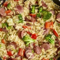 20-minute weeknight dinner made in just ONE skillet! This Sausage Broccoli Orzo combines smoky kielbasa, tender broccoli, and a velvety Parmesan herb sauce&mdash;no heavy cream needed. Perfect for busy nights and meal prep! #thekitchenwhisperer #20minutemeals #onepanmeals