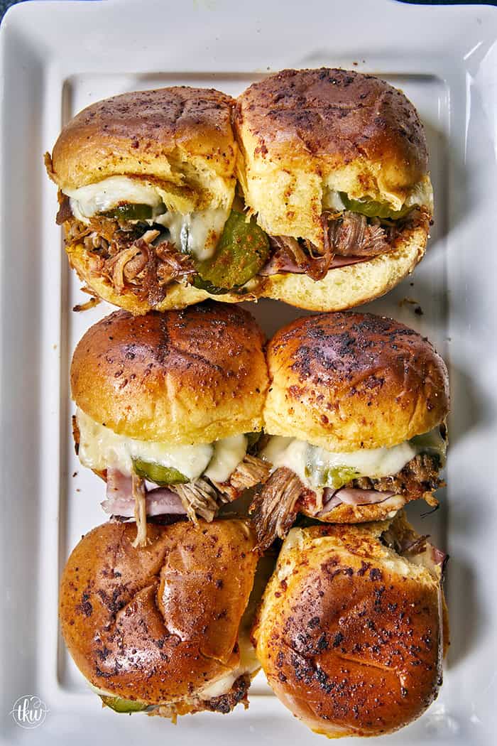 Skip the sandwich press and turn leftover pulled pork into these Easy Baked Cubano Sliders! Layered on sweet brioche rolls with Black Forest ham, dill pickles, Swiss cheese, and brushed with BBQ-spiced butter. Built all in one dish for game day parties, easy weeknight dinners, or casual cookouts.