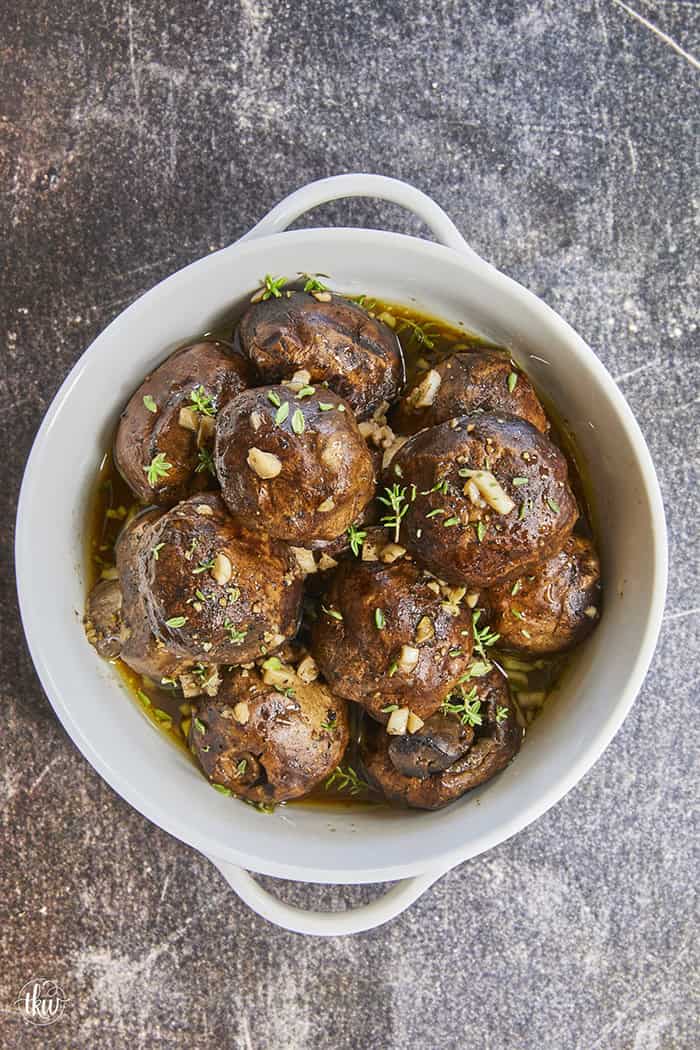 Get tender, juicy mushrooms coated in a rich, bubbling garlic butter glaze with a hit of hardwood smoke. Dry-smoking them at 250°F lets every cap soak up maximum hardwood flavor before taking a cozy butter bath. Tap to learn the simple two-step method that creates the ultimate steakhouse side!