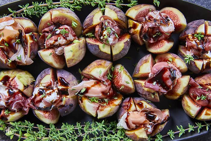 Elegant, easy, and ready in 15 minutes! Fresh figs are stuffed with fluffy whipped goat cheese, wrapped in savory prosciutto, and drizzled with balsamic glaze. Try this simple appetizer today!