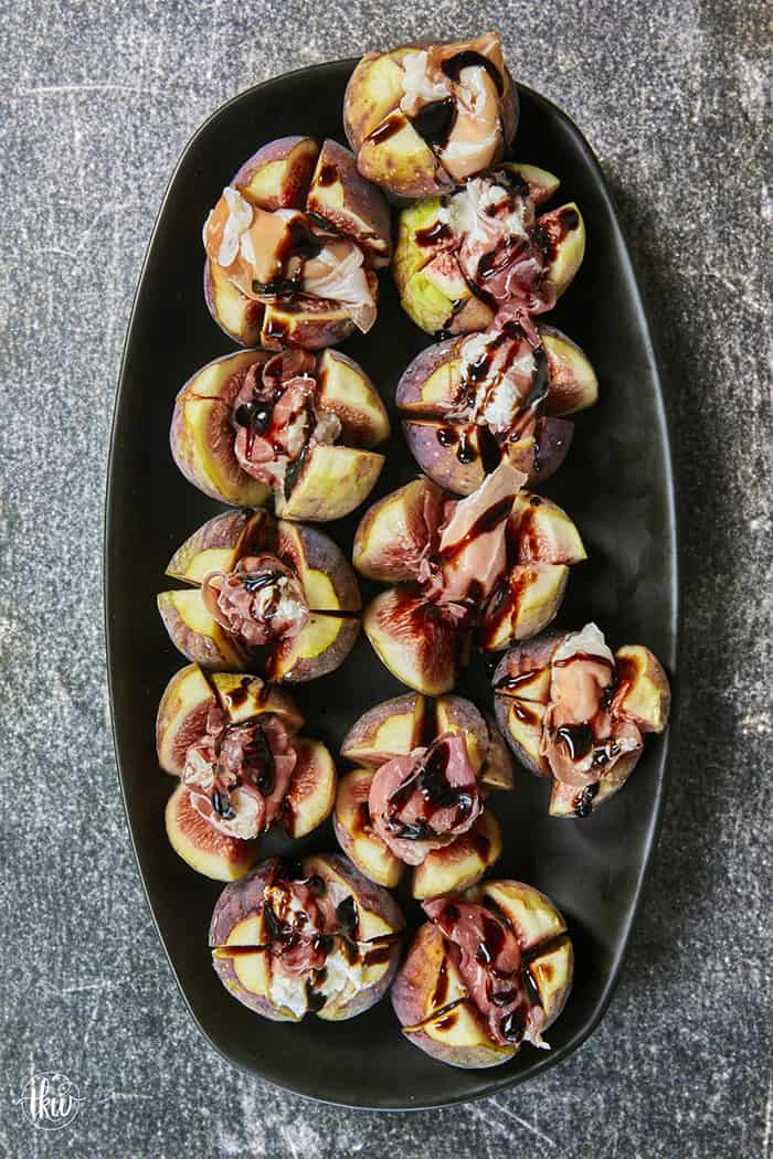 Elegant, easy, and ready in 15 minutes! Fresh figs are stuffed with fluffy whipped goat cheese, wrapped in savory prosciutto, and drizzled with balsamic glaze. Try this simple appetizer today!