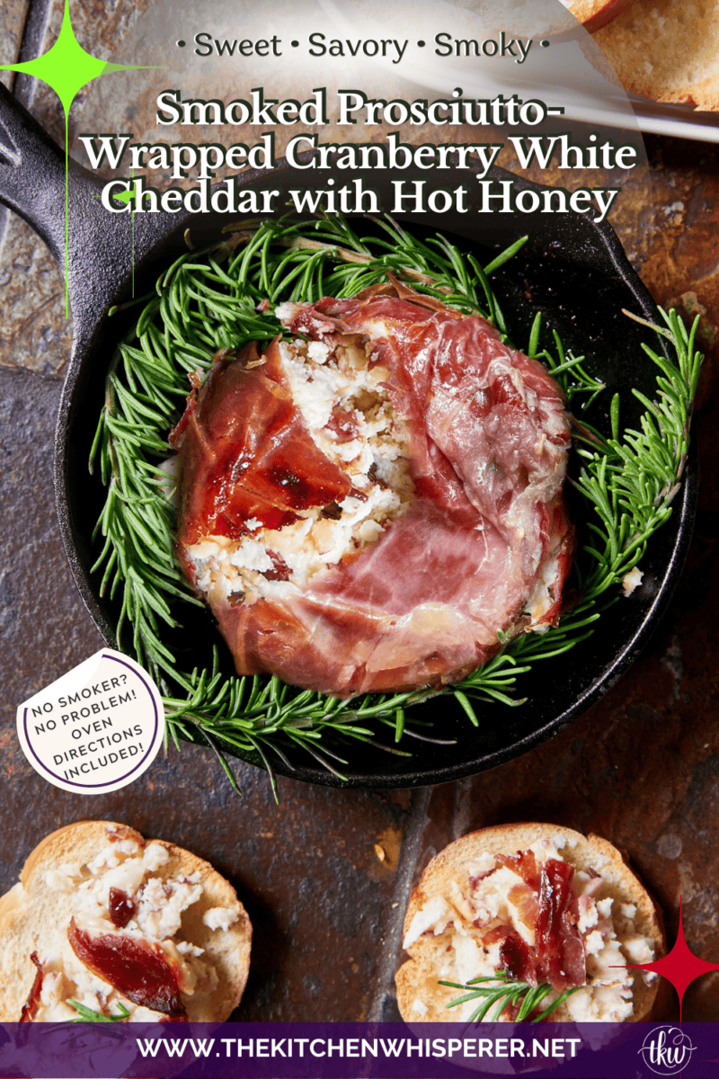 Smoked Prosciutto-Wrapped Cranberry White Cheddar Cheese drizzled with hot honey and fresh rosemary on a serving board with crostini.